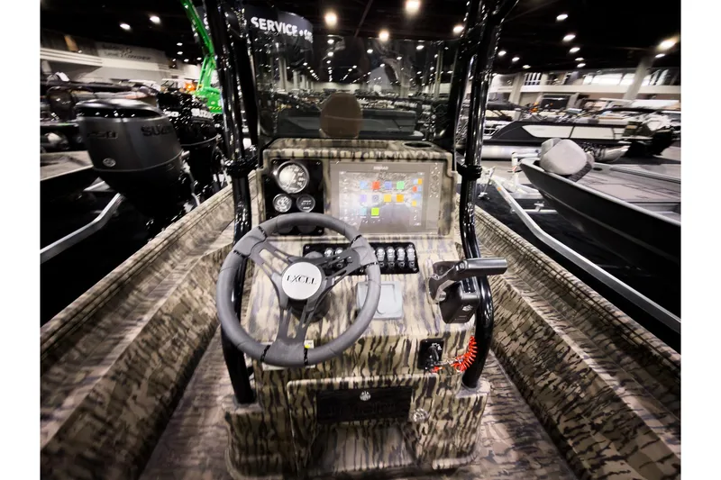 Slide: The Image of 2026 Excel 220 Bay Pro Elite boat interior with steering wheel and control panel. - 5