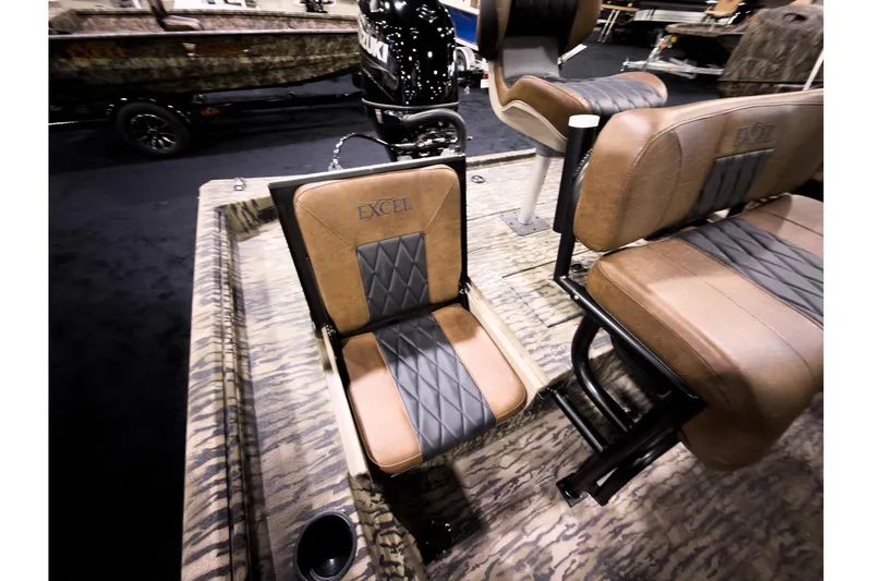 Slide: The Image of 2026 Excel 220 Bay Pro Elite boat interior with stylish seating and camo design. - 9