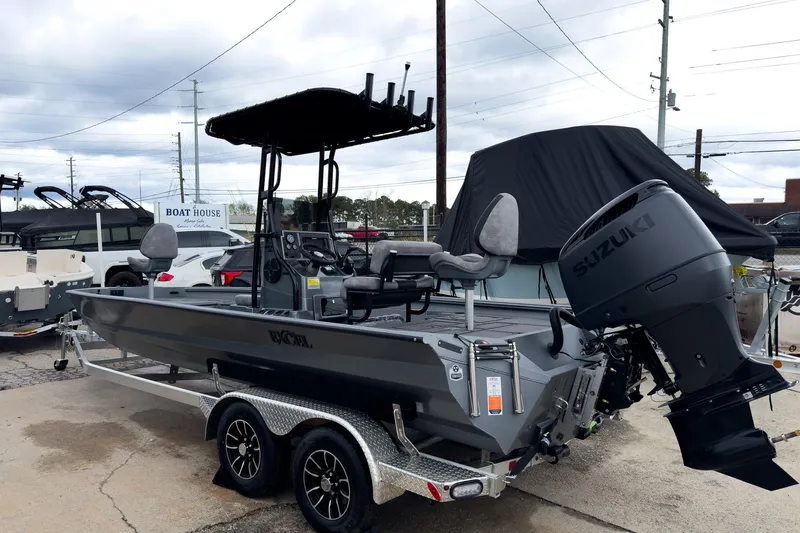 Slide: The Image of 2026 Excel Bay Pro Elite 230 boat with Suzuki engine on a trailer. - 14