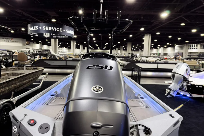 Slide: The Image of 2026 Excel 230 Bay Pro Elite boat showcased at an indoor exhibition. - 2