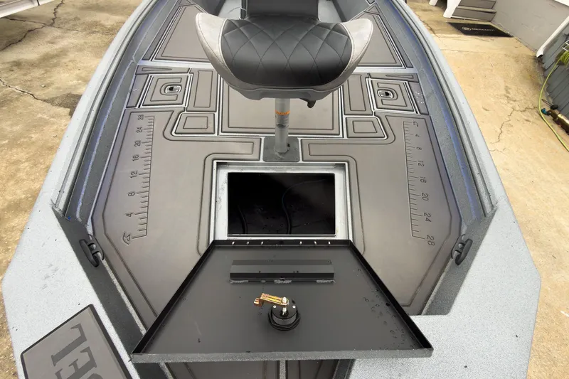 Slide: The Image of 2026 Excel Bay Pro Elite 230 boat deck with seat and storage compartment. - 26
