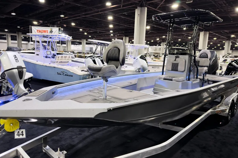 Slide: The Image of 2026 Excel 230 Bay Pro Elite boat displayed at an indoor boat show. - 4
