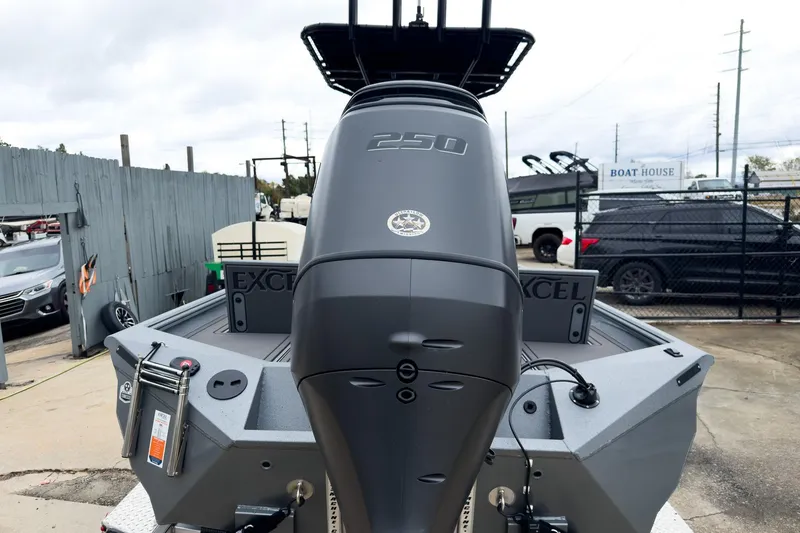 Slide: The Image of 2026 Excel Bay Pro Elite 230 boat with powerful 250 engine, parked outdoors. - 16