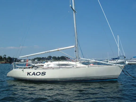 The Image of 1985 X-Yachts X-3/4 Ton sailboat "KAOS" on calm water under clear blue sky. - 1