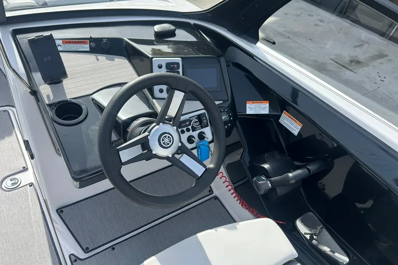 Slide: The Image of 2024 Yamaha Boats AR220 cockpit with steering wheel and control panel. - 11