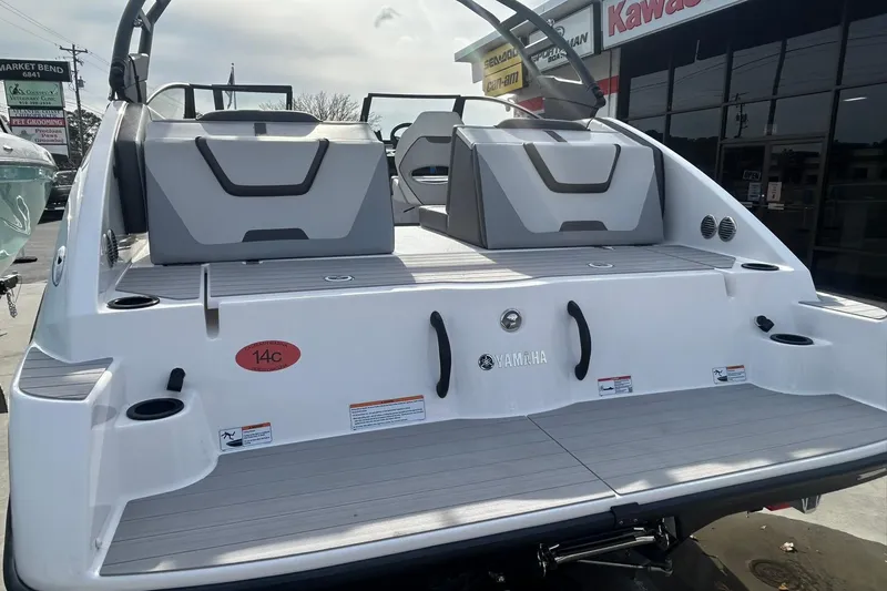 Slide: The Image of 2024 Yamaha Boats AR220 rear view, showcasing sleek design and spacious seating. - 14