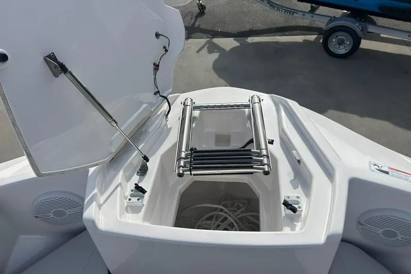 Slide: The Image of 2024 Yamaha Boats AR220 bow storage with ladder and speakers. - 6
