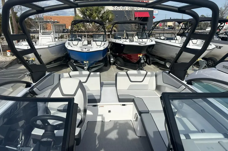 Slide: The Image of 2024 Yamaha Boats AR220 interior with sleek seating and modern design, displayed among other boats. - 7