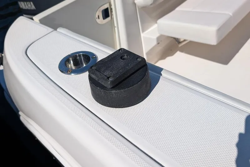 Slide: The Image of 2014 Robalo R305 Walkaround boat deck with rod holder and black accessory. - 18