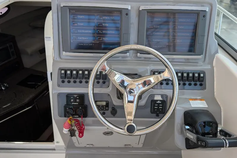 Slide: The Image of 2014 Robalo R305 Walkaround helm with dual Garmin displays and Yamaha controls. - 20