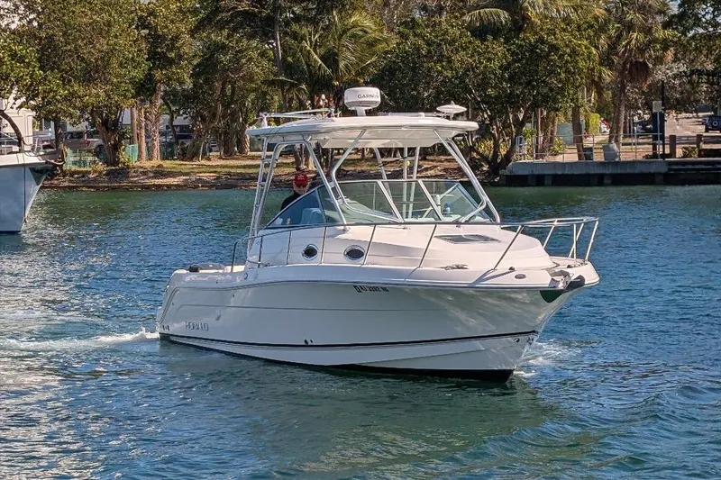 Slide: The Image of 2014 Robalo R305 Walkaround boat cruising on a sunny day. - 4