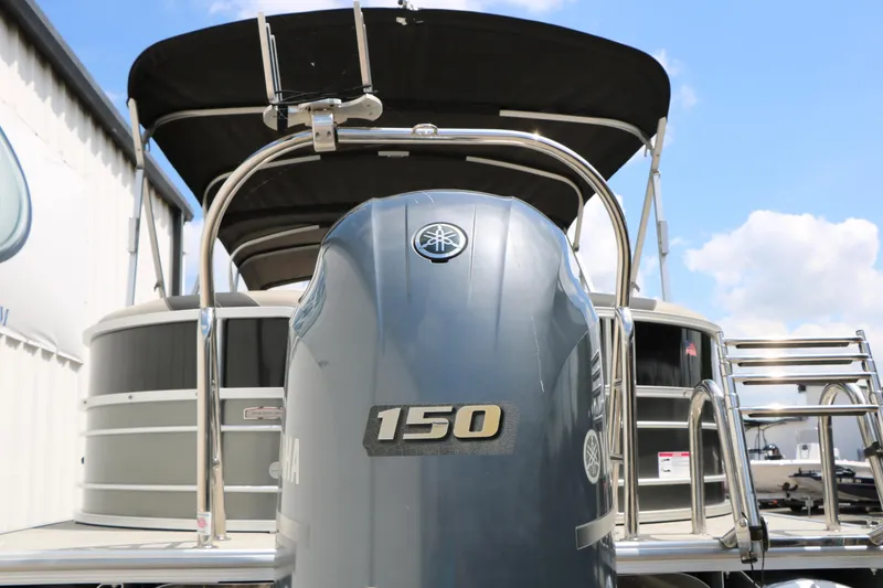 Slide: The Image of 2020 Trifecta 24RF LE pontoon boat with Yamaha 150 outboard motor, docked under blue sky. - 10