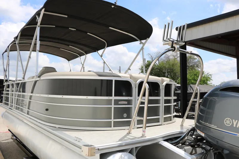 Slide: The Image of 2020 Trifecta 24RF LE pontoon boat with canopy and Yamaha outboard motor. - 11