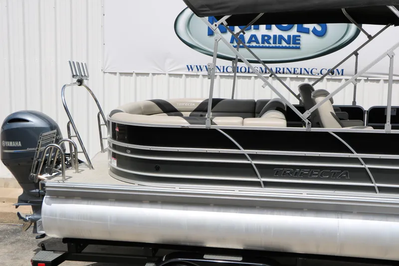 Slide: The Image of 2020 Trifecta 24RF LE pontoon boat with Yamaha engine, displayed at a marine dealership. - 13