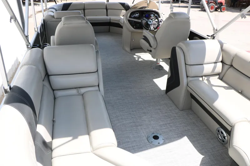 Slide: The Image of 2020 Trifecta 24RF LE pontoon boat interior with plush seating and modern helm. - 24