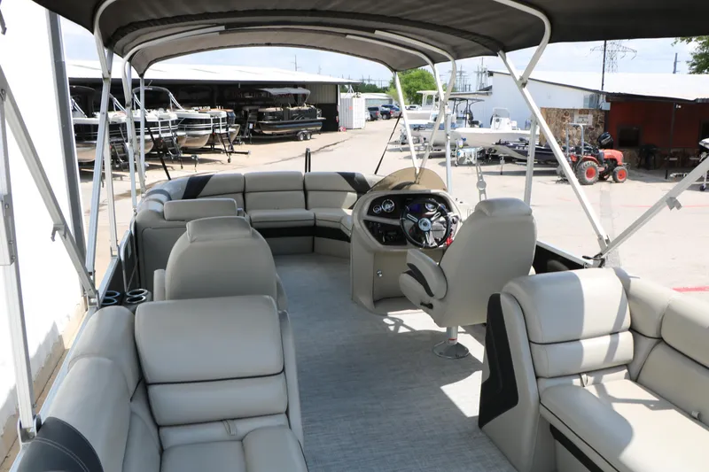 Slide: The Image of 2020 Trifecta 24RF LE pontoon boat interior with spacious seating and steering console. - 25