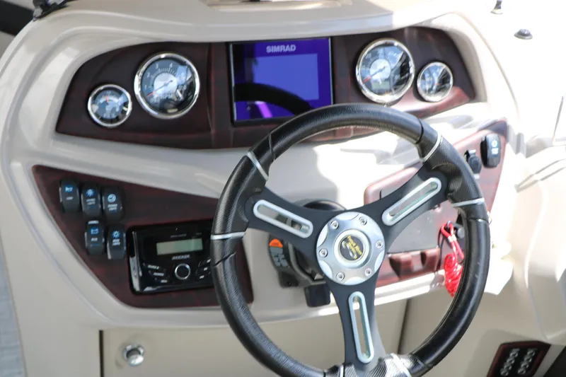 Slide: The Image of 2020 Trifecta 24RF LE boat dashboard with steering wheel and control panel. - 30