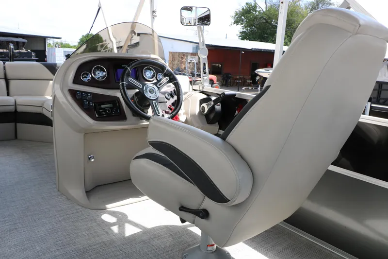 Slide: The Image of 2020 Trifecta 24RF LE boat interior with steering wheel and captain's chair. - 36