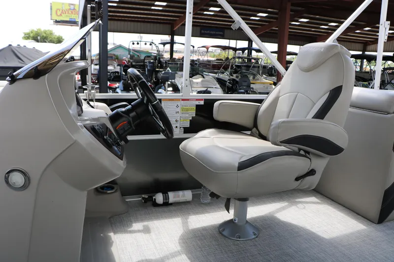 Slide: The Image of Captain's chair and helm of 2020 Trifecta 24RF LE pontoon boat in showroom. - 37