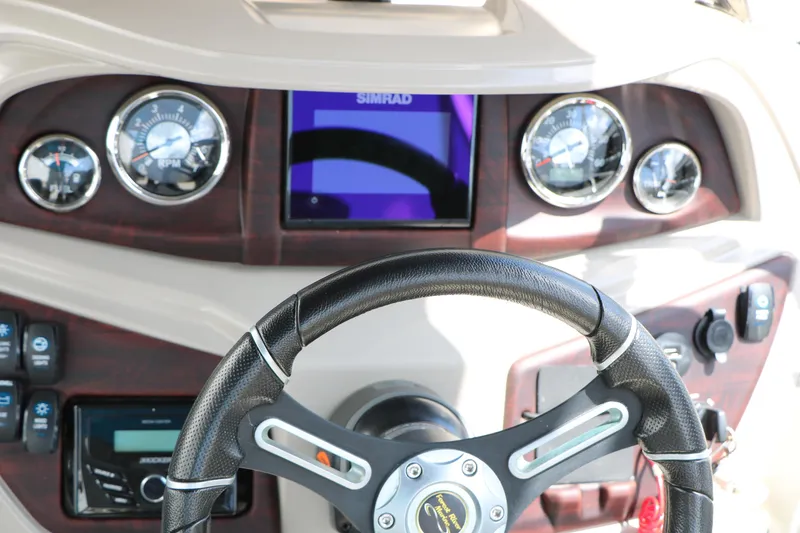 Slide: The Image of Steering wheel and dashboard of 2020 Trifecta 24RF LE boat with gauges and controls. - 39