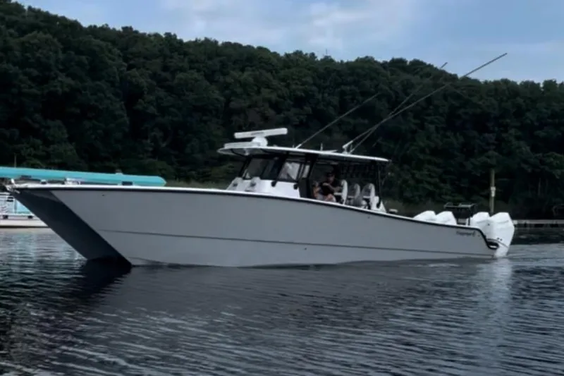 Slide: The Image of Freeman 42LR 2024 boat on calm water with wooded background. - 2