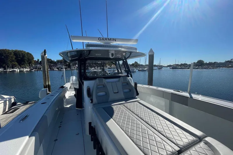 Slide: The Image of 2024 Freeman 42LR boat docked, featuring sleek design and advanced Garmin navigation system. - 7