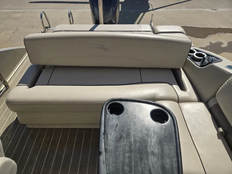 Slide: The Image of Interior of a 2017 Bennington R23 pontoon boat with seating and cup holders. - 5