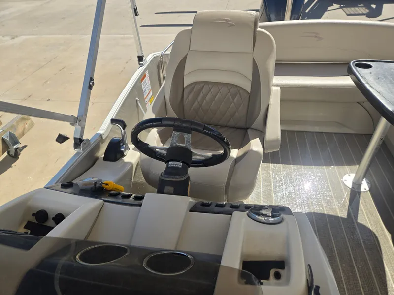 Slide: The Image of Interior of a 2017 Bennington R23 pontoon boat with steering wheel. - 6