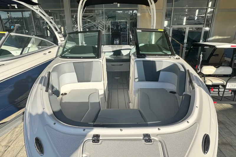 Slide: The Image of 2026 Chaparral 21 SSi OB boat interior with gray seating and open windshield. - 1