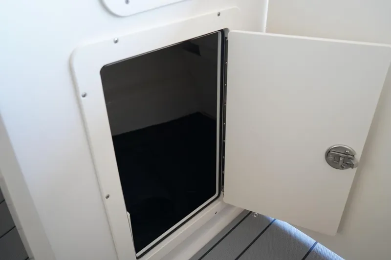 Slide: The Image of Open storage compartment on 2026 Chaparral 21 SSi OB boat. - 12
