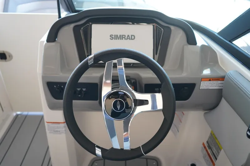 Slide: The Image of Steering wheel and dashboard of 2026 Chaparral 21 SSi OB boat with Simrad display. - 13