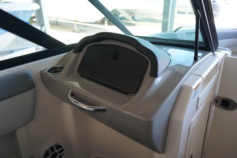 Slide: The Image of Interior view of 2026 Chaparral 21 SSi OB boat dashboard with storage compartment. - 14