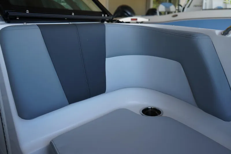 Slide: The Image of 2026 Chaparral 21 SSi OB boat interior seating with cup holder, featuring sleek design. - 5