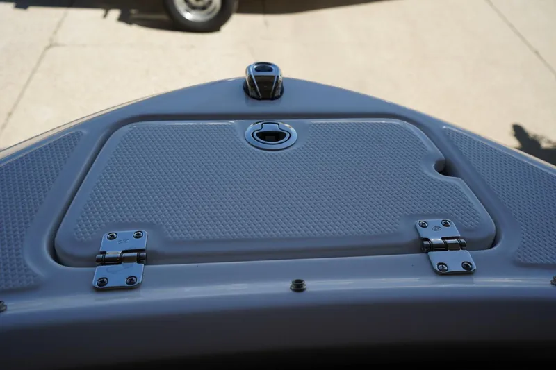 Slide: The Image of 2026 Chaparral 21 SSi OB boat hatch with textured surface and hinges. - 9