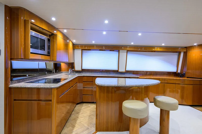 Slide: The Image of Luxurious kitchen interior of 2015 Viking 62 Convertible yacht with wood cabinetry and modern appliances. - 33