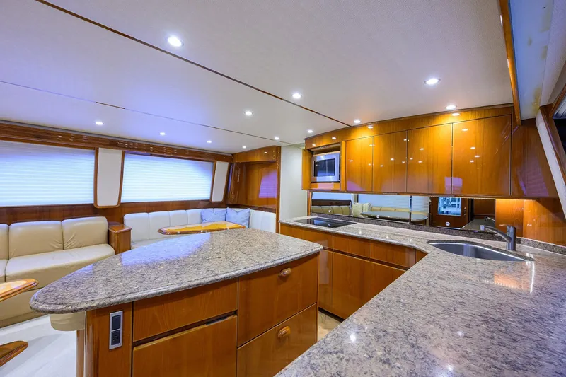 Slide: The Image of Luxurious interior of 2015 Viking 62 Convertible yacht with modern kitchen and seating area. - 34