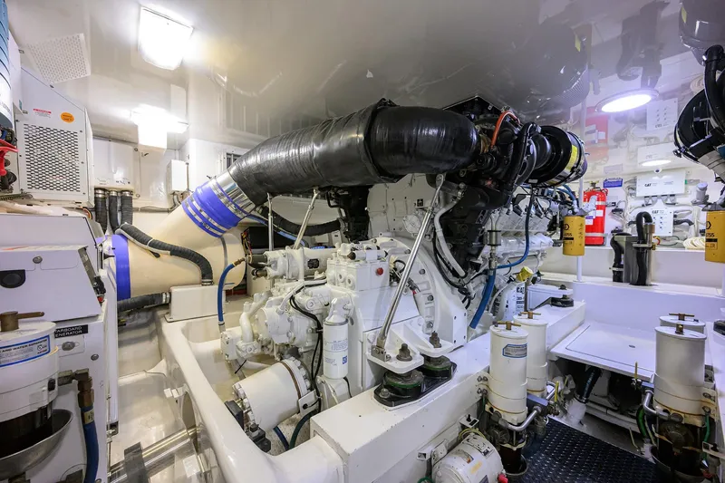 Slide: The Image of Engine room of 2015 Viking 62 Convertible yacht, showcasing machinery and equipment. - 58