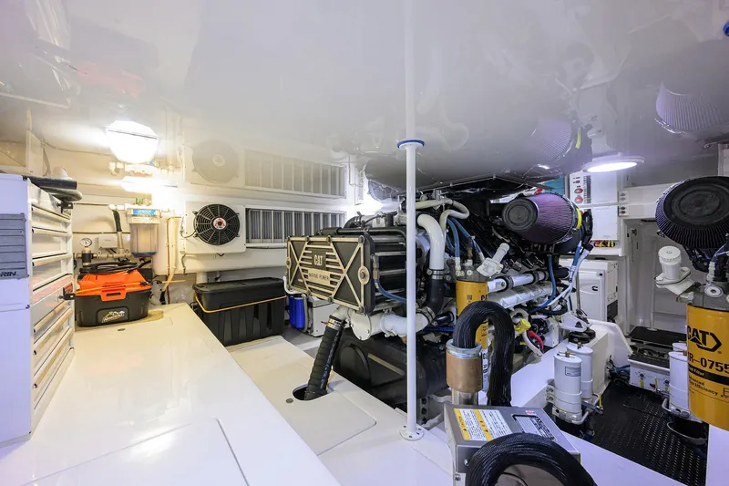 Slide: The Image of Engine room of 2015 Viking 62 Convertible yacht, featuring CAT marine power systems. - 63