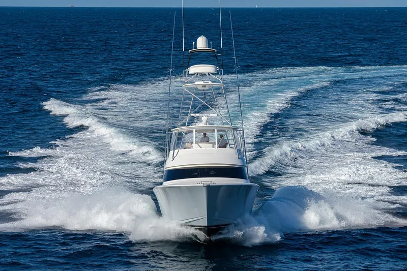 Slide: The Image of 2015 Viking 62 Convertible yacht cruising swiftly on open ocean waters. - 75