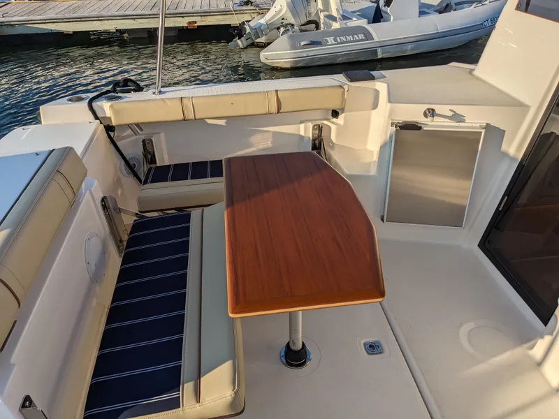 Slide: The Image of Interior of a 2021 Ranger Tugs R-27 with wooden table and seating. - 15