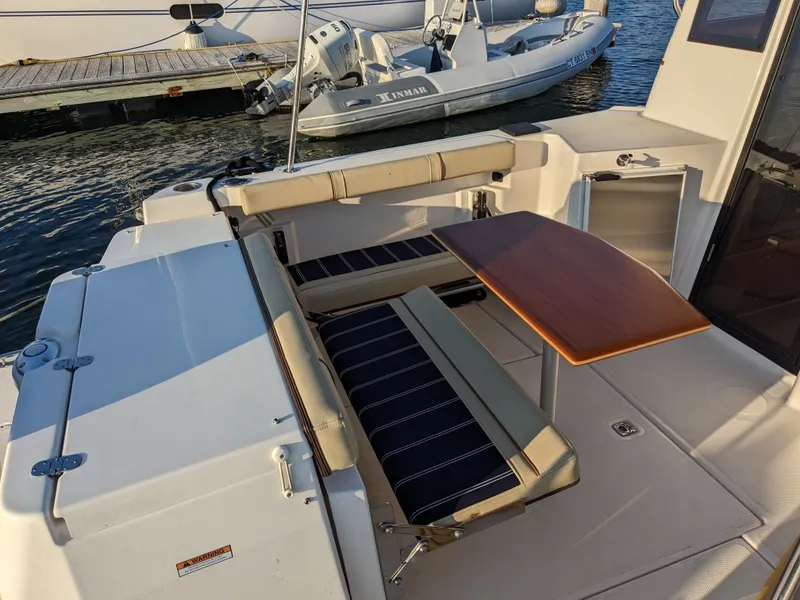 Slide: The Image of Interior of a 2021 Ranger Tugs R-27 boat with table and seating area. - 16