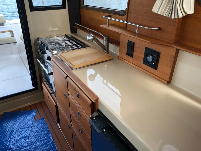 Slide: The Image of Interior of Ranger Tugs R-27 yacht kitchen, 2021 model. - 17