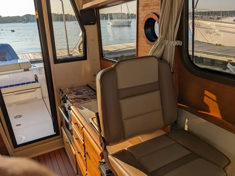 Slide: The Image of Interior of a 2021 Ranger Tugs R-27 boat with harbor view. - 18