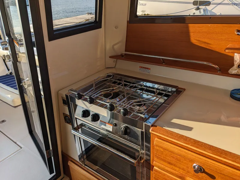 Slide: The Image of Interior of 2021 Ranger Tugs R-27 with stove and oven. - 19