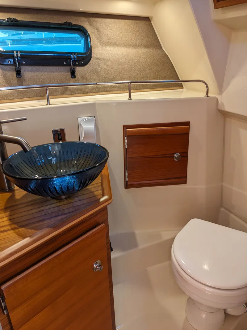 Slide: The Image of Interior of Ranger Tugs R-27 yacht, bathroom with glass sink. - 24
