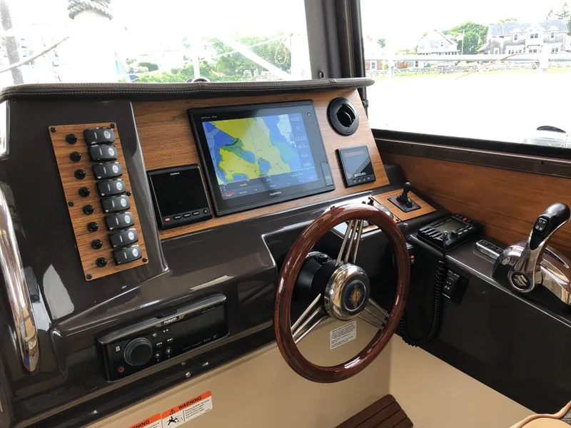 Slide: The Image of Ranger Tugs R-27 helm, 2021 model, featuring navigation system. - 7