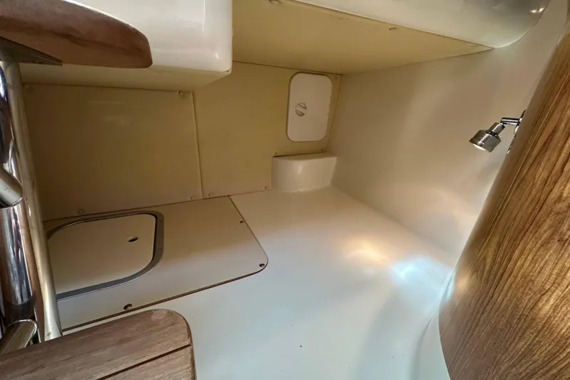 Slide: The Image of 2007 Pursuit OS 285 Offshore cabin interior with wooden accents and compact design. - 15
