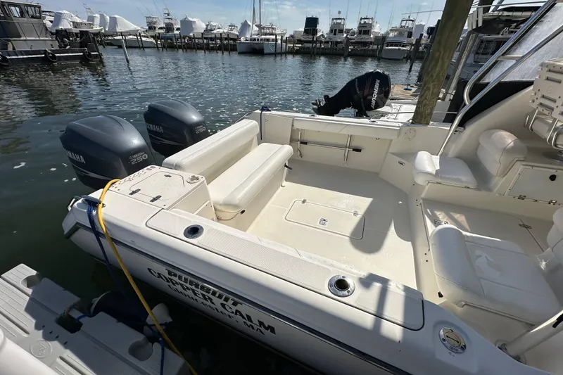 Slide: The Image of 2007 Pursuit OS 285 Offshore boat docked, featuring twin Yamaha 250 engines. - 18