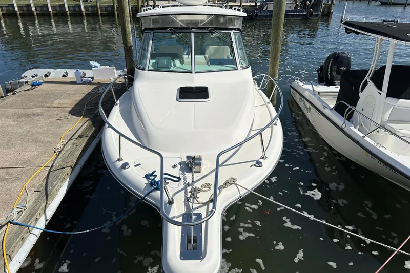Slide: The Image of 2007 Pursuit OS 285 Offshore boat docked at marina, front view. - 3