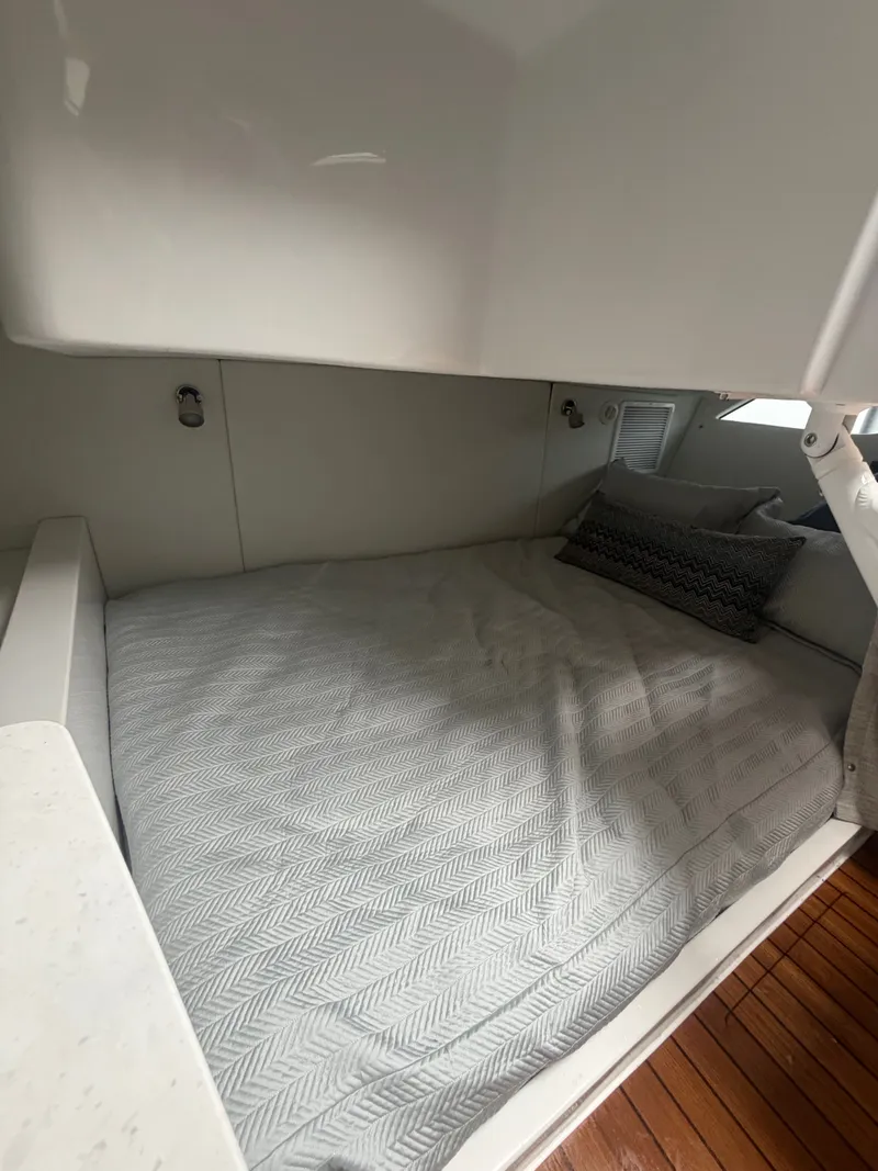 Slide: The Image of 2024 Intrepid Valor cabin with cozy bed and pillows. - 16